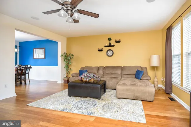 a living room with fireplace furniture and a wooden floor