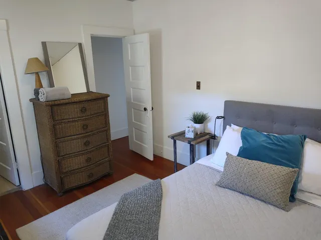 a living room with furniture and mirror