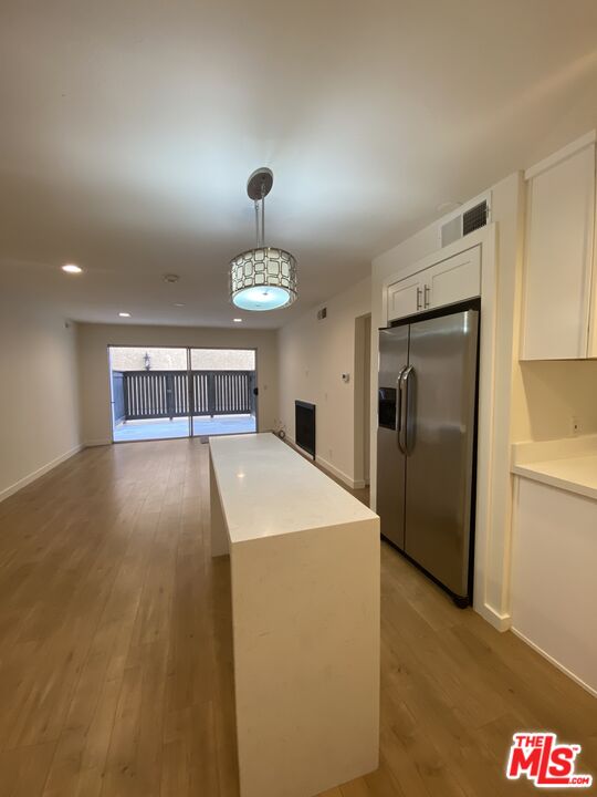 1101 Raintree Circle, Unit 101 Culver City, CA 90230 - Photo 5 of 12 a hall with refrigerator and window
