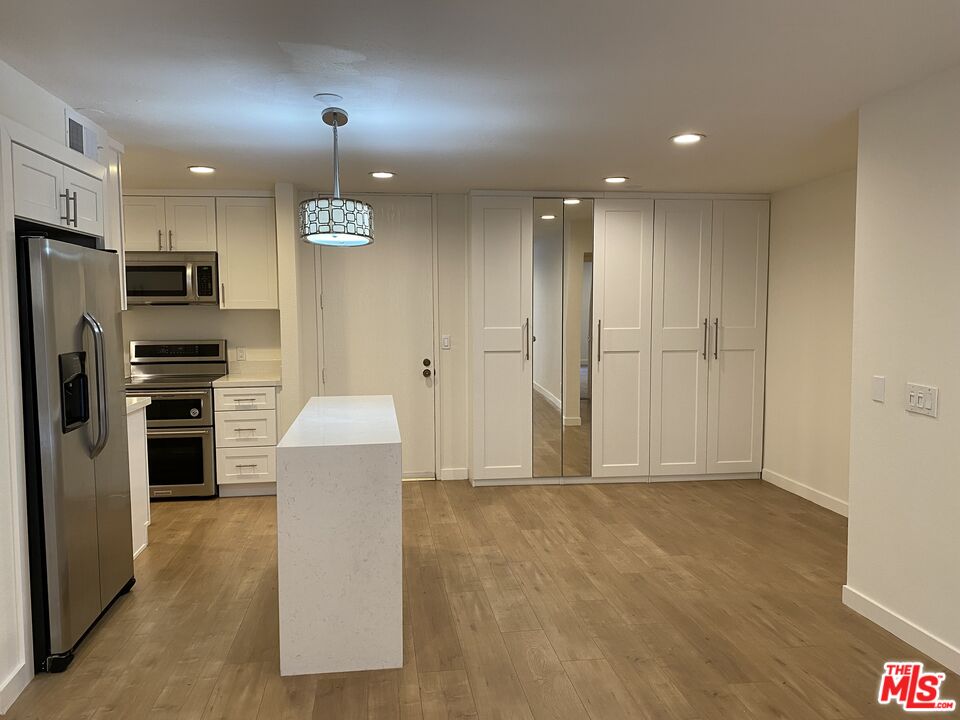 1101 Raintree Circle, Unit 101 Culver City, CA 90230 - Photo 6 of 12 a view of kitchen with refrigerator and window