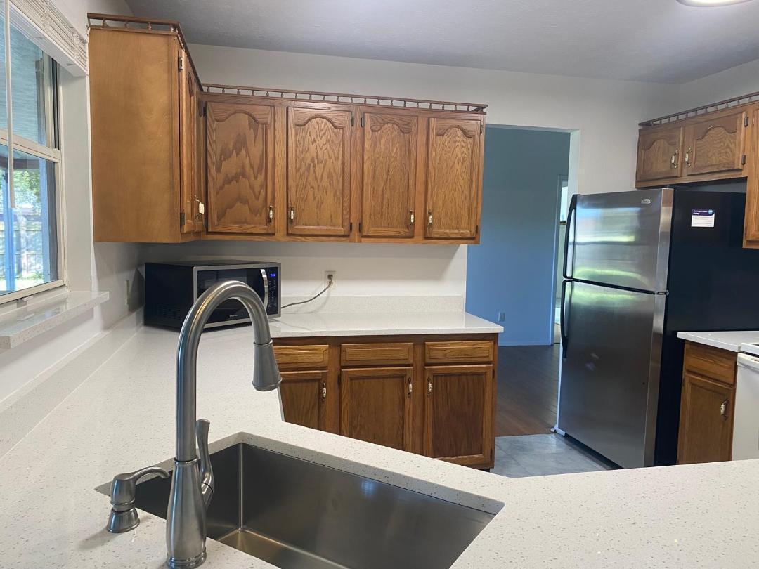 901 Southwest Gaitor Avenue Port St. Lucie, FL 34953 - Photo 3 of 11 a kitchen with stainless steel appliances kitchen island a refrigerator and sink