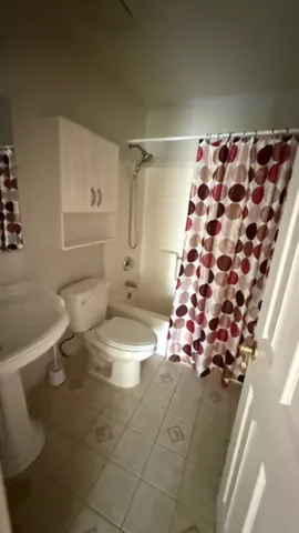 a bathroom with a toilet sink and shower