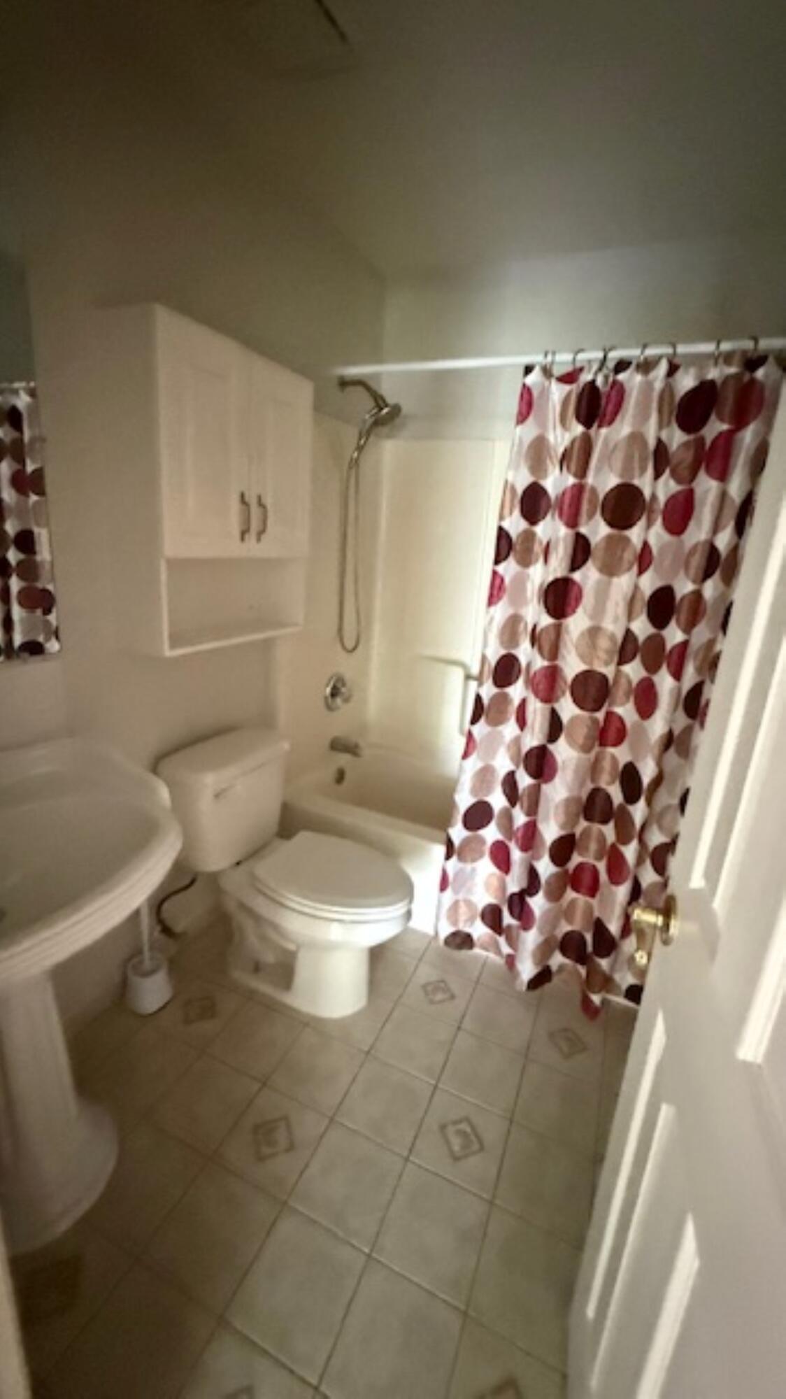 901 Southwest Gaitor Avenue Port St. Lucie, FL 34953 - Photo 6 of 11 a bathroom with a toilet sink and shower