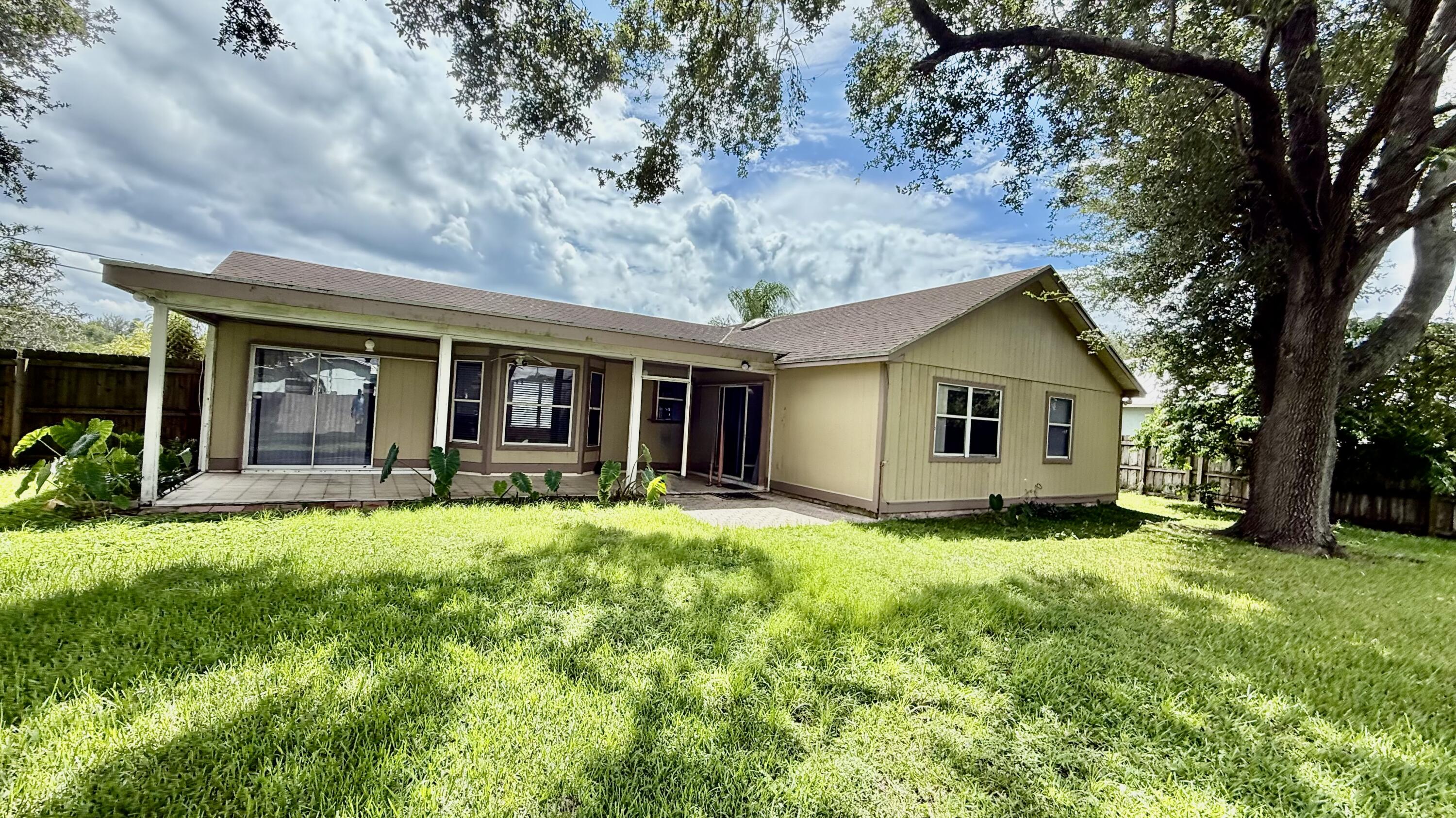 901 Southwest Gaitor Avenue Port St. Lucie, FL 34953 - Photo 10 of 11 a view of a house with a yard and sitting area