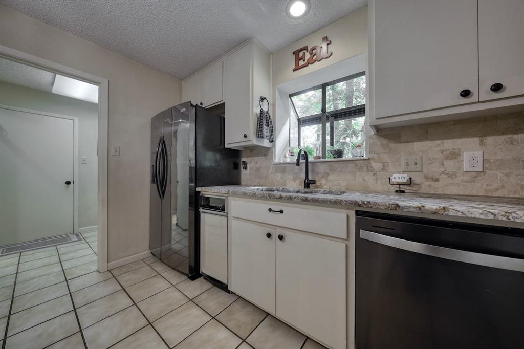 1649 Morningside Trail Hideaway, TX 75771 - Photo 12 of 40 a kitchen with stainless steel appliances granite countertop a sink stove and refrigerator