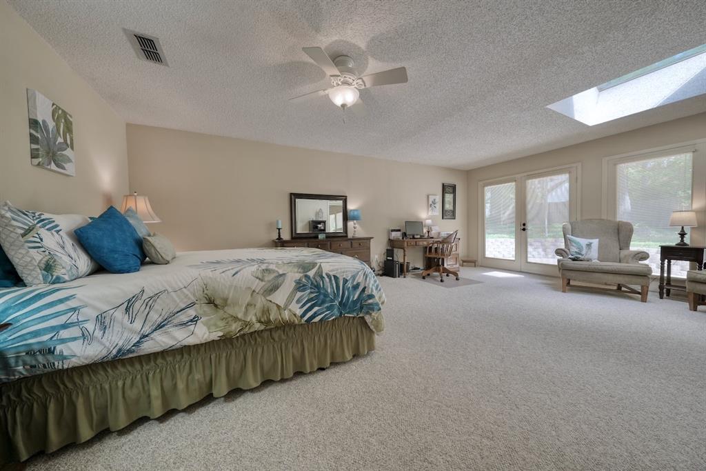 1649 Morningside Trail Hideaway, TX 75771 - Photo 20 of 40 a bedroom with a large bed a table and chair