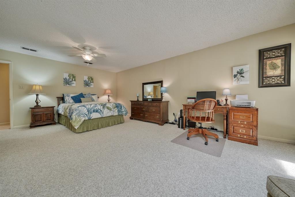 1649 Morningside Trail Hideaway, TX 75771 - Photo 23 of 40 a bedroom with furniture and a lamp