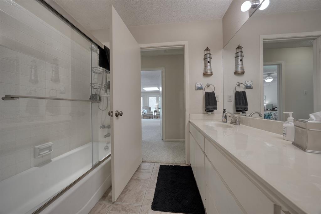 1649 Morningside Trail Hideaway, TX 75771 - Photo 31 of 40 a bathroom with a double vanity sink a toilet and shower