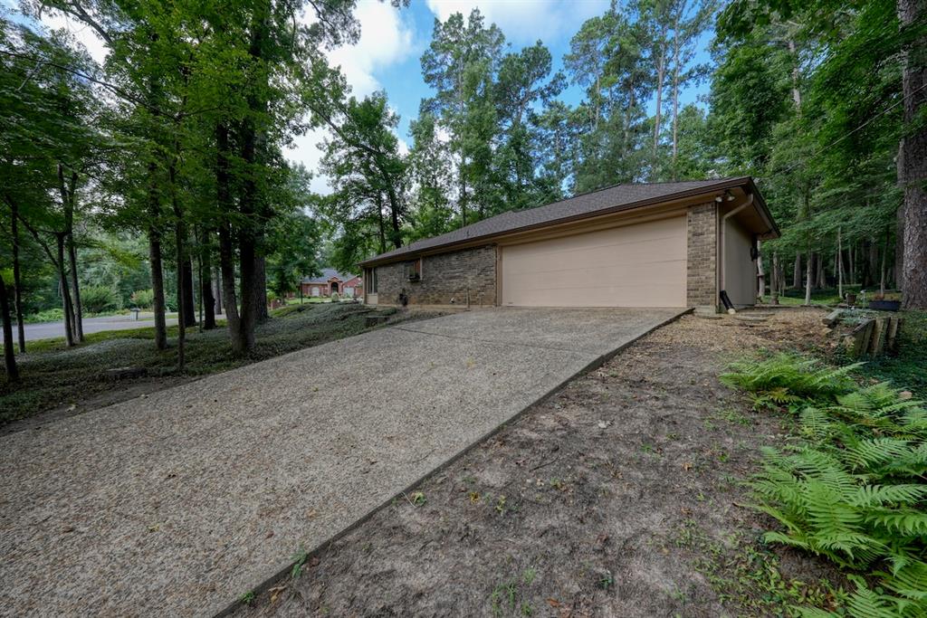 1649 Morningside Trail Hideaway, TX 75771 - Photo 39 of 40 a backyard of a house with large trees and outdoor seating