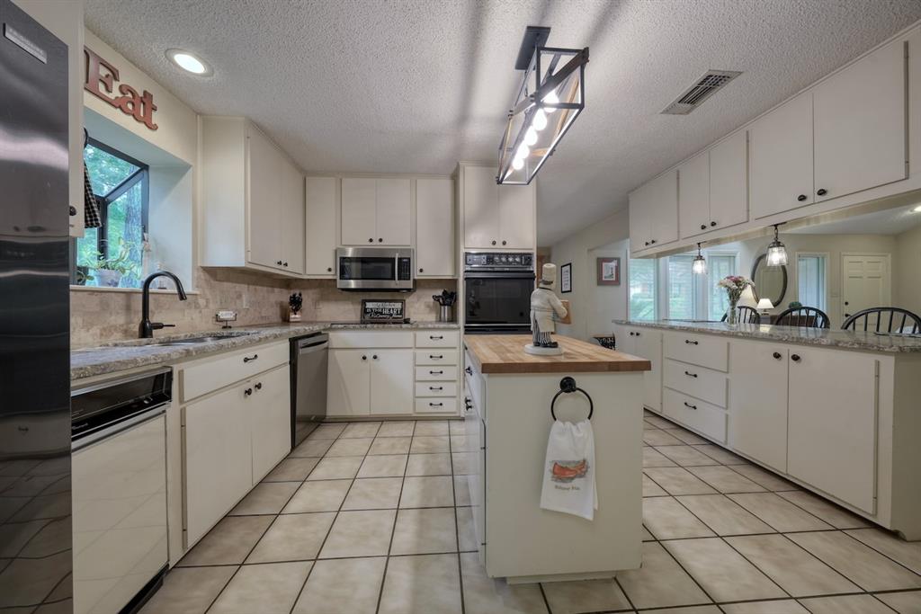 1649 Morningside Trail Hideaway, TX 75771 - Photo 10 of 40 a kitchen with a sink window and cabinets