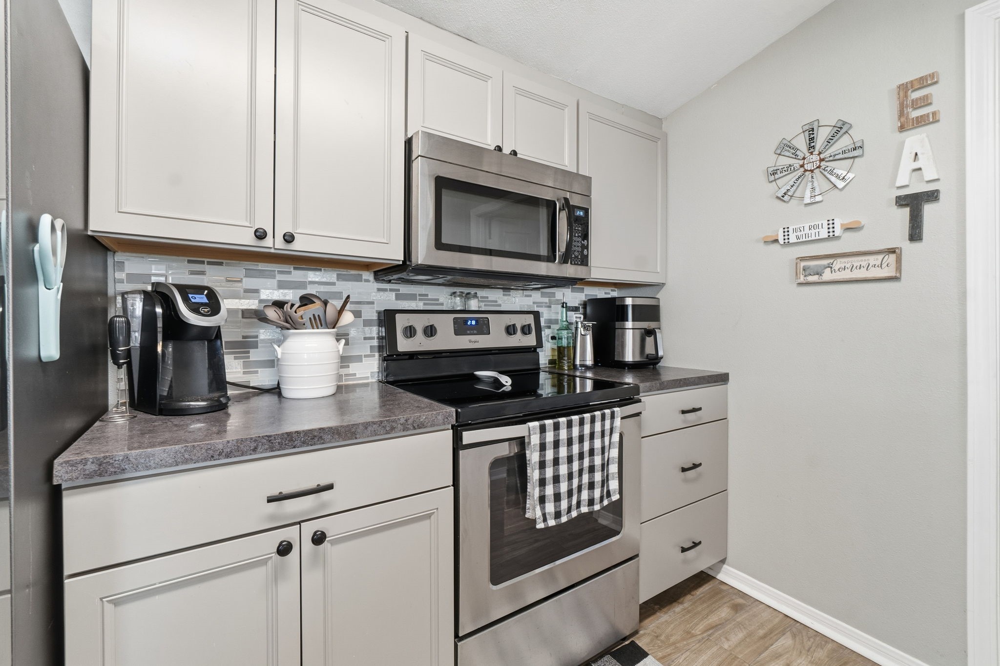 192 Miller Road Livingston, TX 77351 - Photo 15 of 36 a kitchen with stainless steel appliances granite countertop a stove a microwave and cabinets
