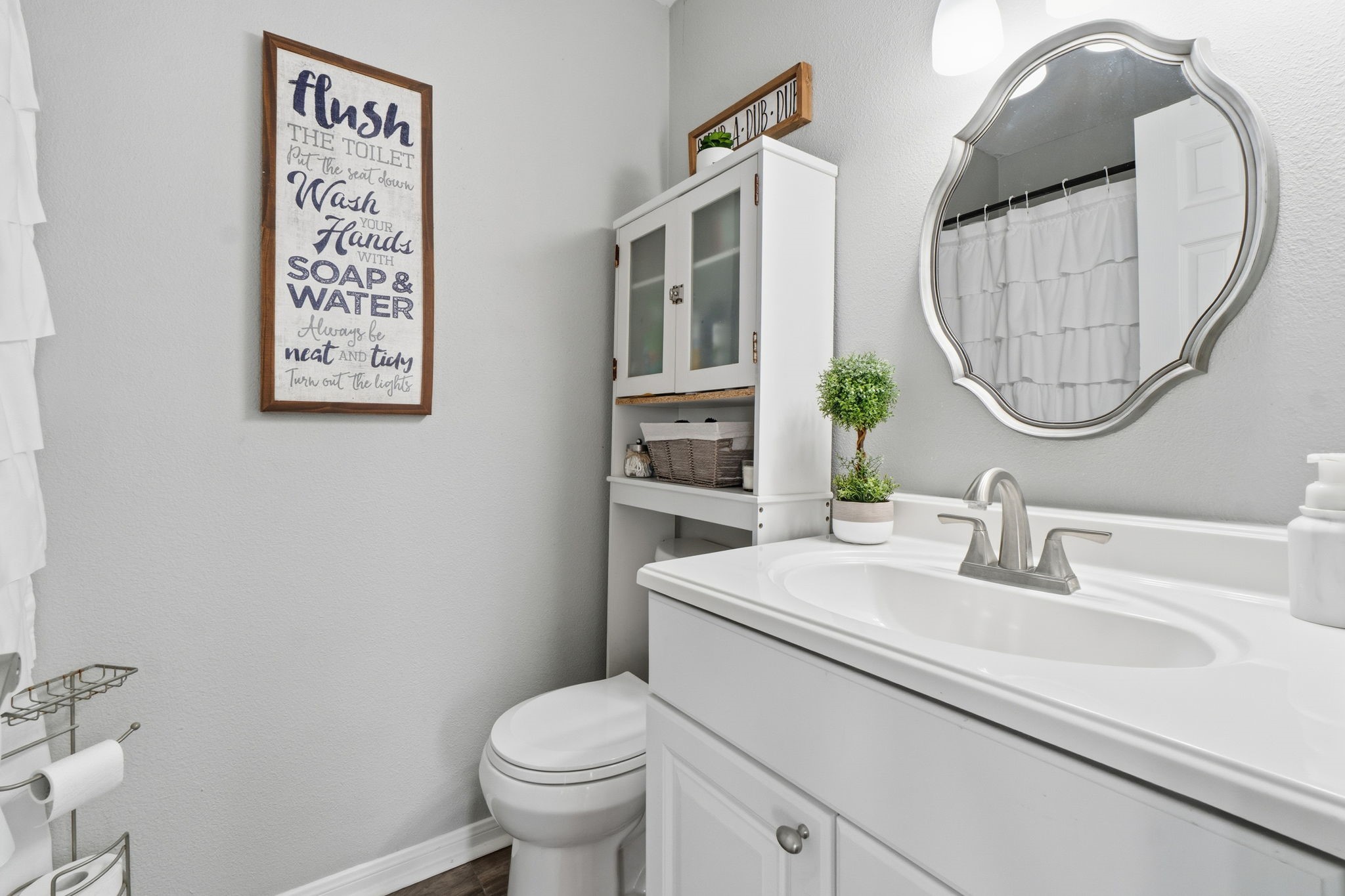 192 Miller Road Livingston, TX 77351 - Photo 21 of 36 a bathroom with a toilet a sink and a mirror