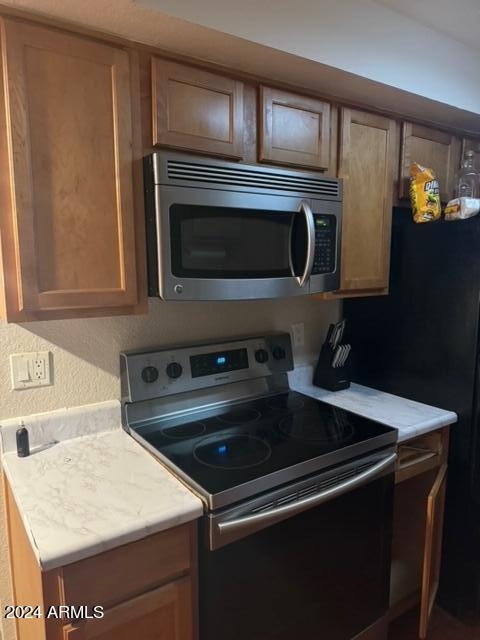1336 East Mountain View Road, Unit 202 Phoenix, AZ 85020 - Photo 10 of 23 a kitchen with granite countertop cabinets and steel stainless steel appliances