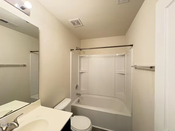 a bathroom with a toilet and shower