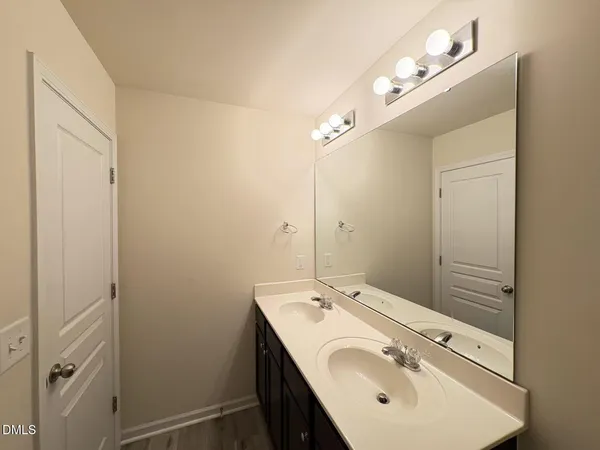 a bathroom with a sink and mirror
