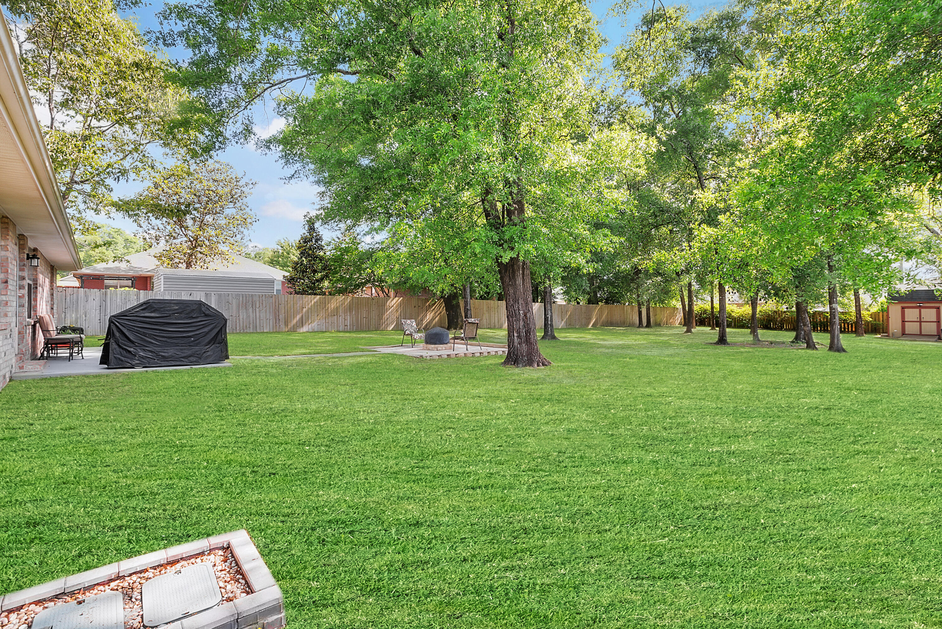 2389 Genevieve Way Crestview, FL 32536 - Photo 11 of 44 a backyard of a house with lots of green space