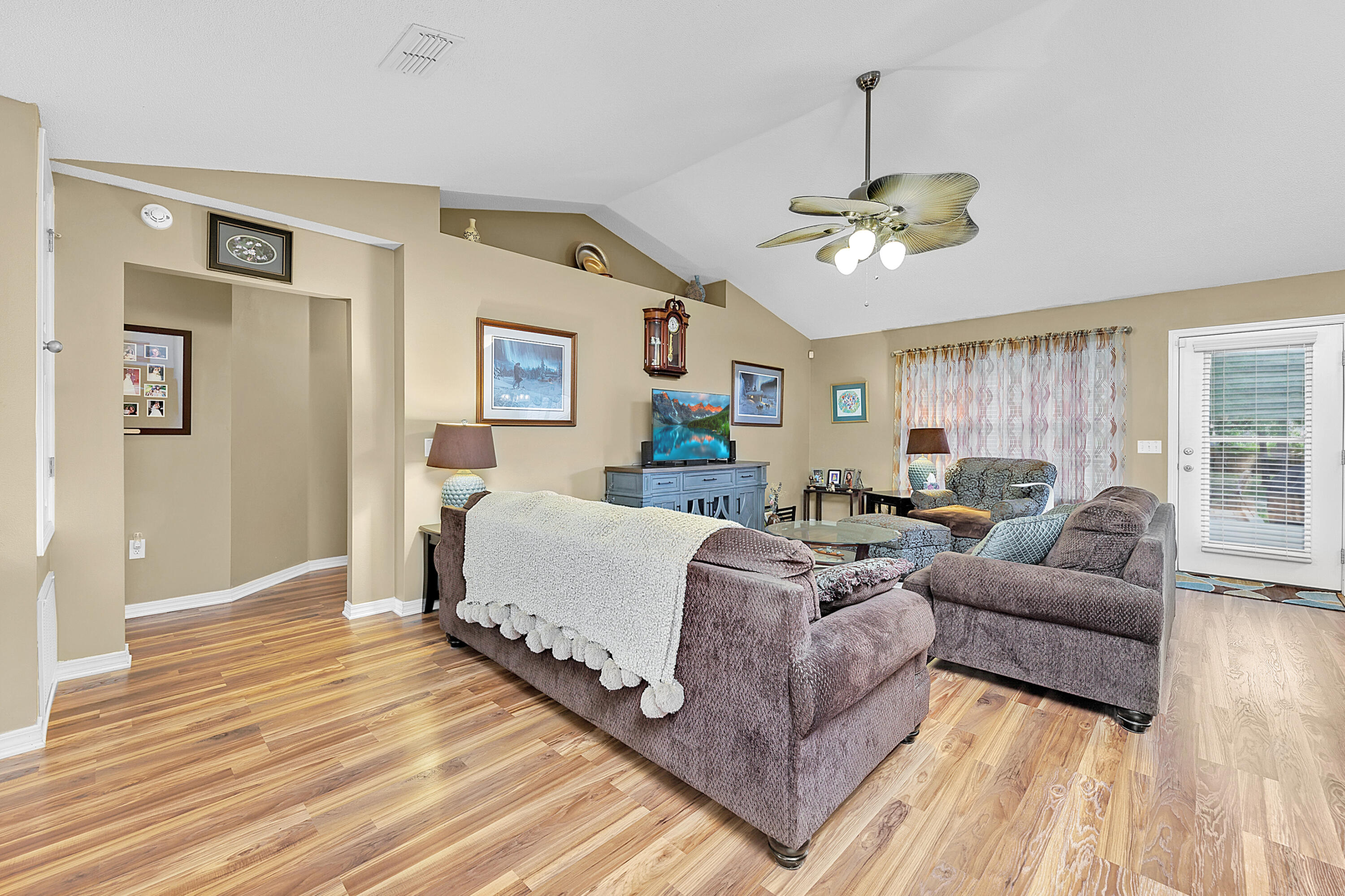2389 Genevieve Way Crestview, FL 32536 - Photo 17 of 44 a living room with furniture chandelier and a wooden floor