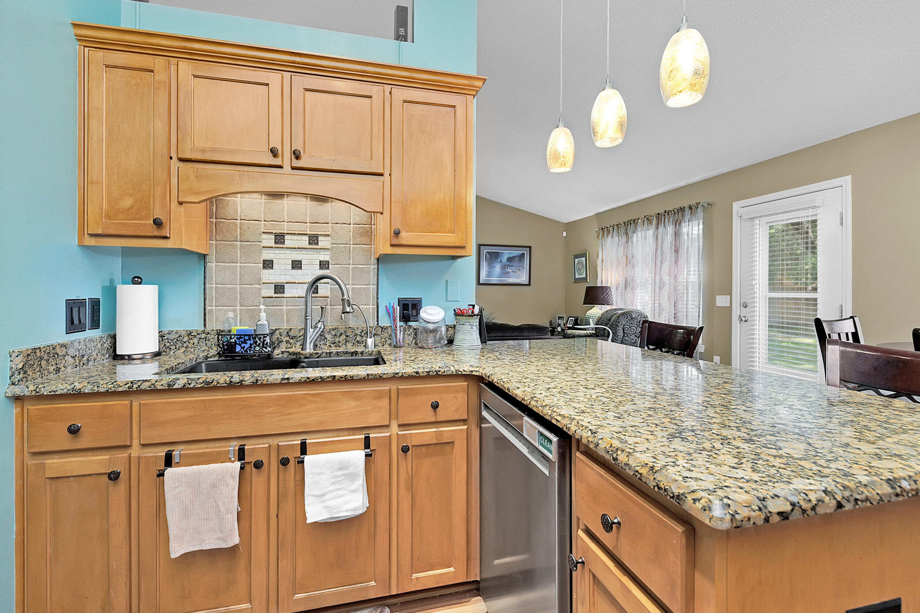 2389 Genevieve Way Crestview, FL 32536 - Photo 20 of 44 a kitchen with stainless steel appliances granite countertop a sink a stove cabinets counter space and living room view
