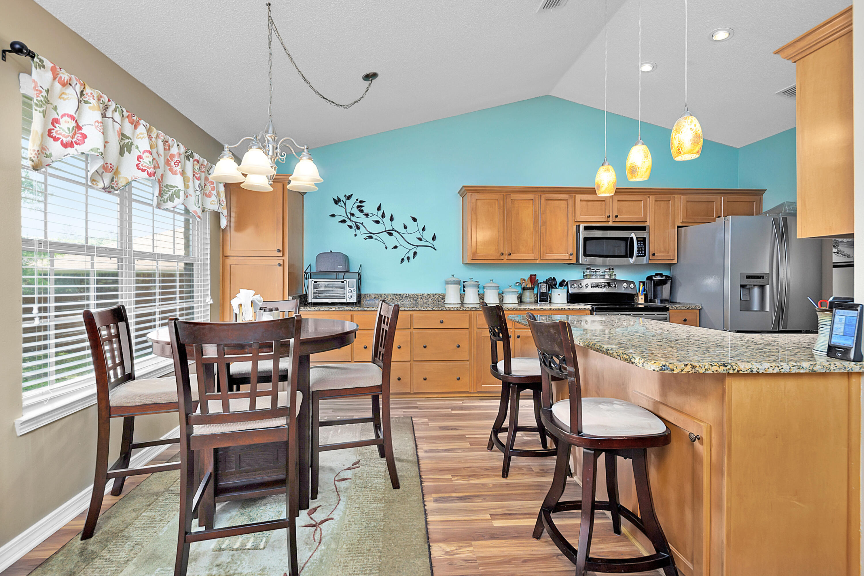 2389 Genevieve Way Crestview, FL 32536 - Photo 25 of 44 a view of a dining room with furniture a chandelier and wooden floor