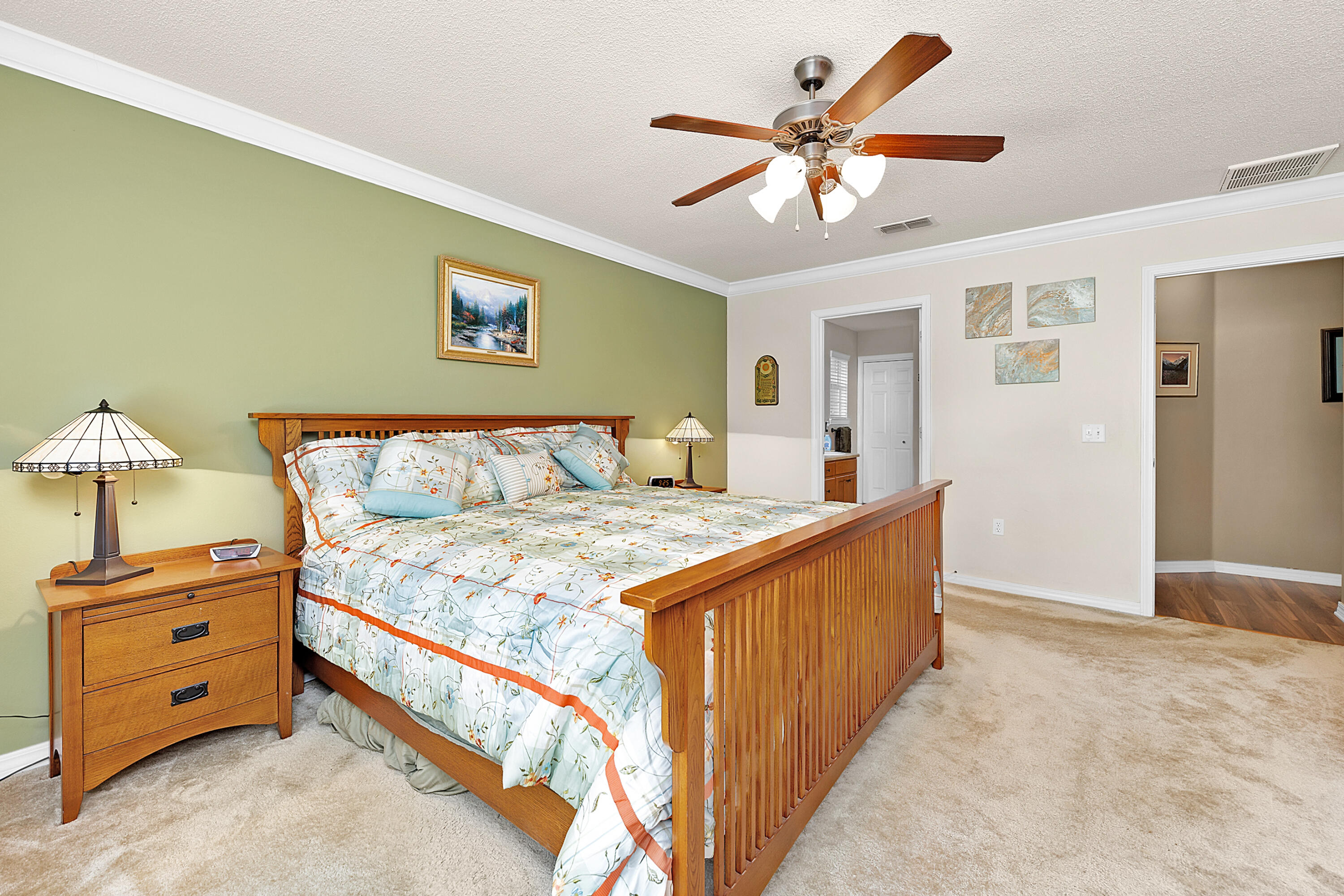 2389 Genevieve Way Crestview, FL 32536 - Photo 36 of 44 a large bedroom with a bed and a chandelier