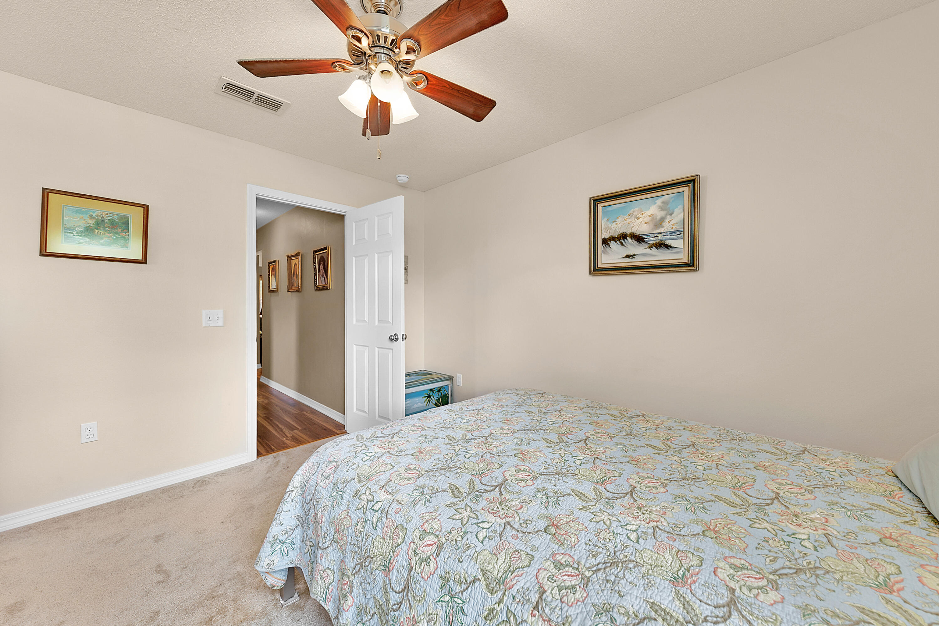 2389 Genevieve Way Crestview, FL 32536 - Photo 41 of 44 a bedroom with a bed and a chandelier