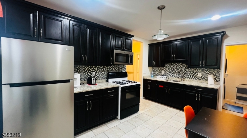 26 Harding Terrace, Unit 1 Newark, NJ 07112 - Photo 12 of 12 a kitchen with stainless steel appliances granite countertop a refrigerator and a sink