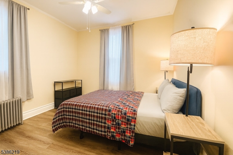 26 Harding Terrace, Unit 1 Newark, NJ 07112 - Photo 7 of 12 a bedroom with a bed and a chandelier