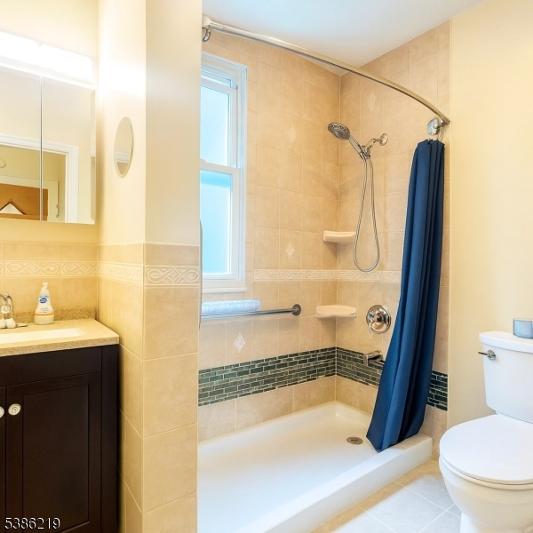 26 Harding Terrace, Unit 1 Newark, NJ 07112 - Photo 8 of 12 a bathroom with a sink a toilet and shower