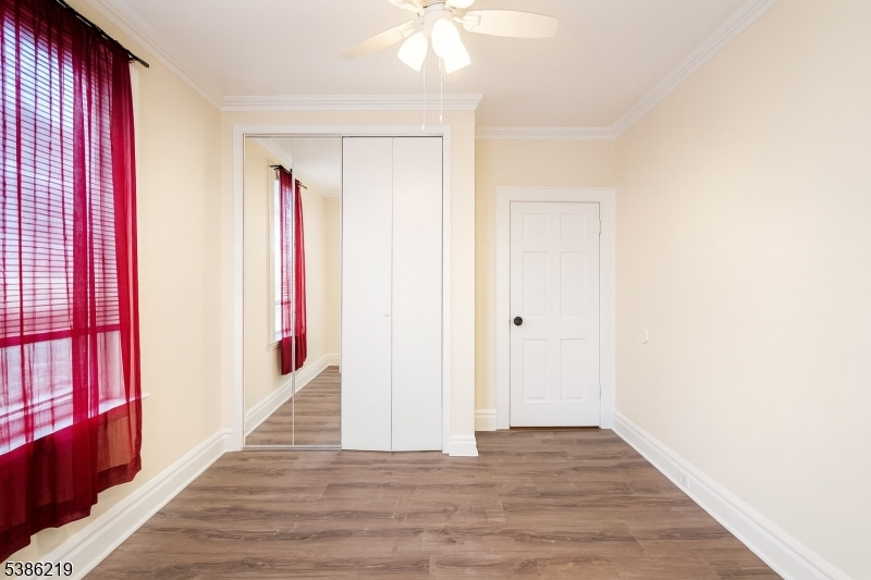 26 Harding Terrace, Unit 1 Newark, NJ 07112 - Photo 9 of 12 a view of a livingroom with wooden floor and a ceiling fan