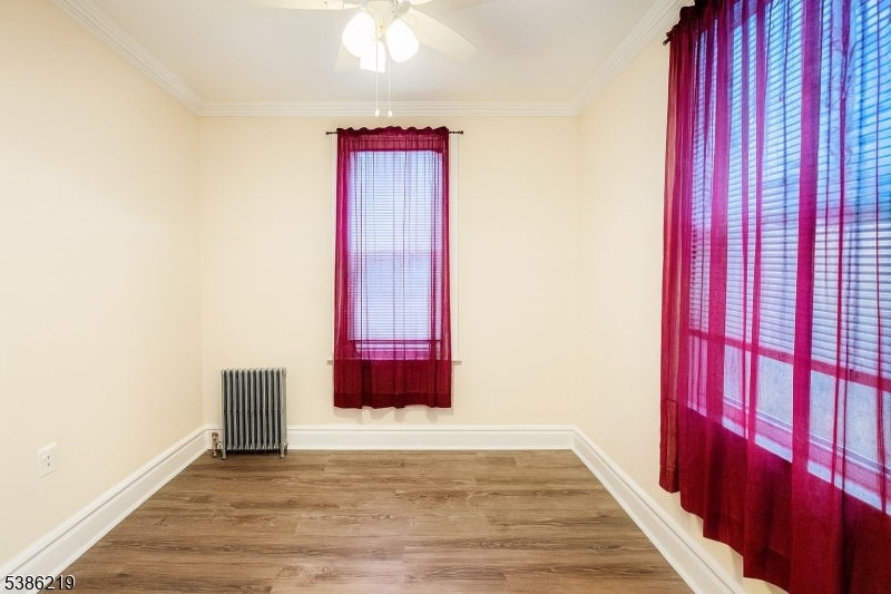 26 Harding Terrace, Unit 1 Newark, NJ 07112 - Photo 10 of 12 a view of a room with wooden floor and windows