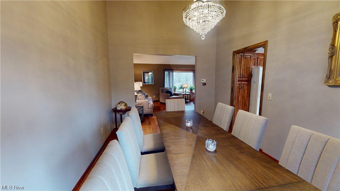 2980 Worrell Road Willoughby, OH 44094 - Photo 16 of 43 Dining area featuring a chandelier, hardwood / wood-style flooring, and a towering ceiling