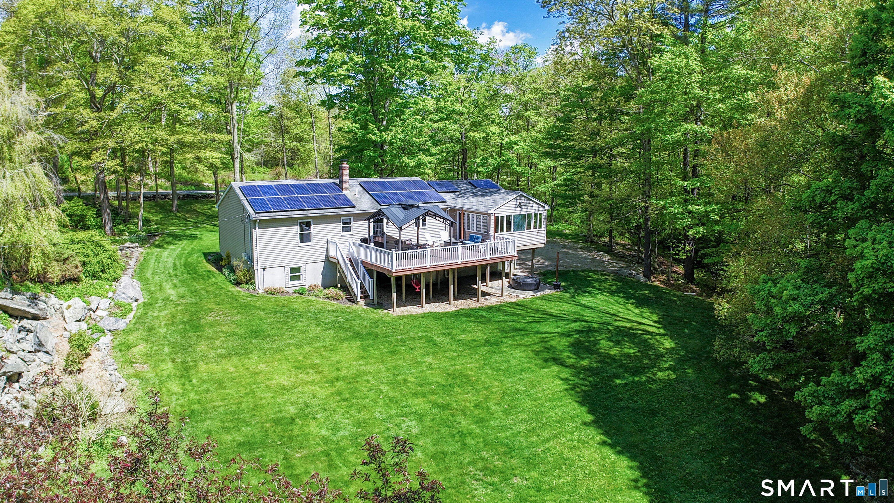 309 O'Leary Road Thompson, CT 06277 - Photo 3 of 40 an aerial view of a house with a yard table and chairs