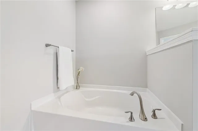 a white bath tub sitting next to a white sink