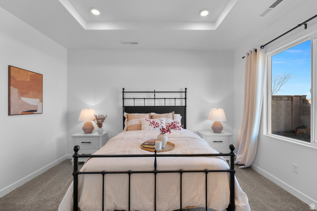 1589 South Fins Road, Unit 4178 Washington, UT 84780 - Photo 23 of 30 Bedroom featuring a tray ceiling with recessed lighting, a large window, white walls, and gray carpet