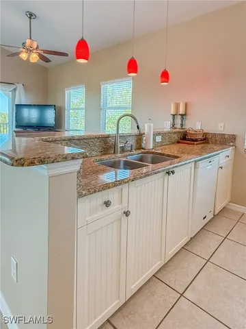 a kitchen with a stove a sink and a refrigerator