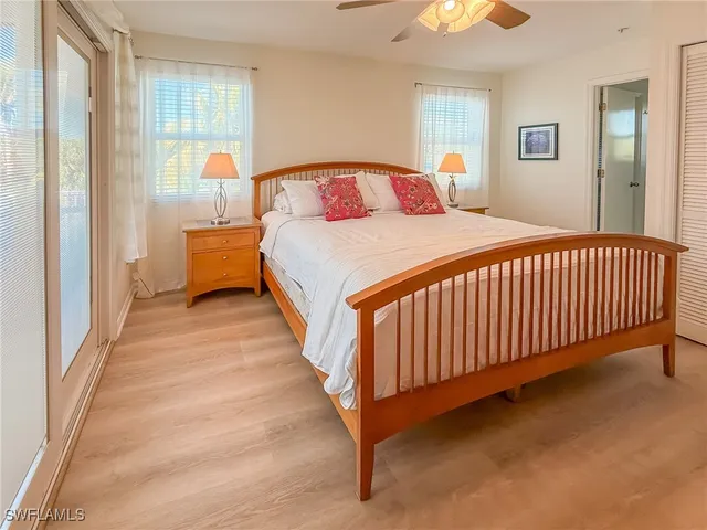 a bedroom with a large bed and a chandelier