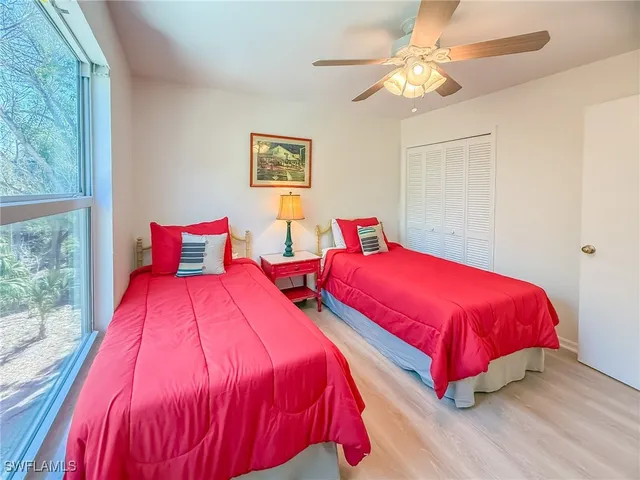 a view of a bedroom with wooden floor and iron stairs