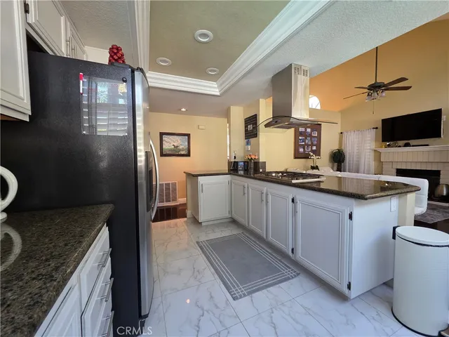 a kitchen with granite countertop a sink and a stove top oven