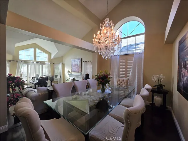 a living room with furniture or chandelier and a dining table