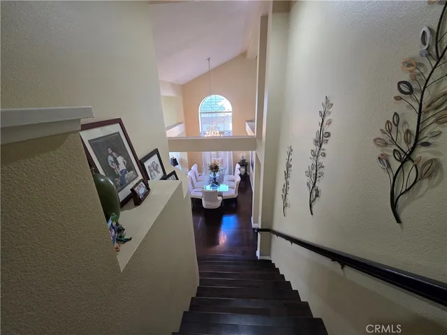 a view of a hallway with wooden floor and stairs