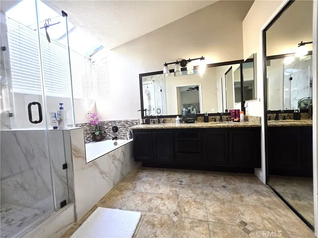 a bathroom with a sink vanity and mirror
