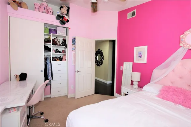 a bedroom with a bed and a desk