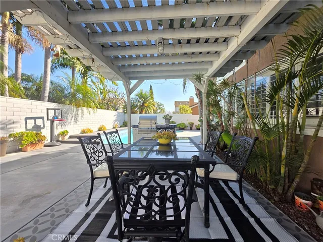 a view of a patio with table and chairs and potted plants