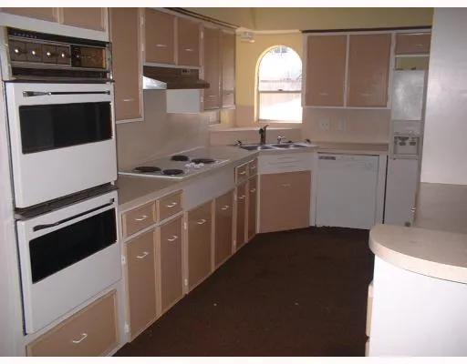 a kitchen with a stove and a microwave