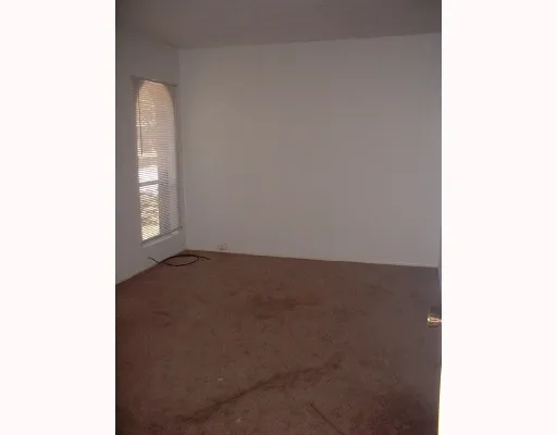 a view of an empty room with windows