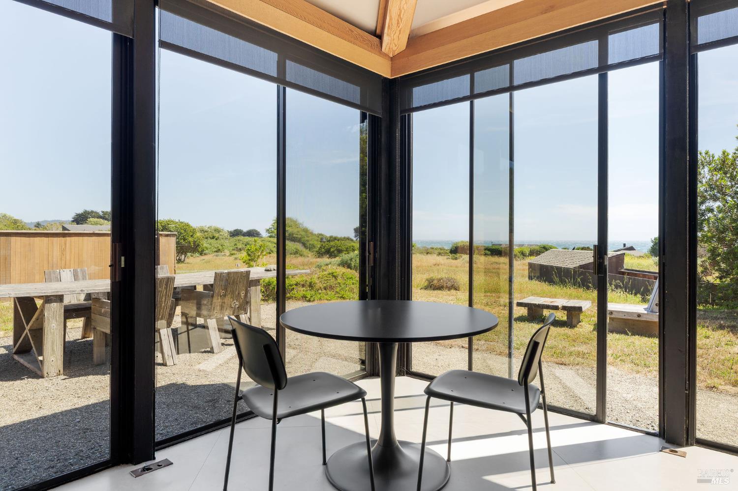39412 Pacific Reach The Sea Ranch, CA 95497 - Photo 12 of 31 a view of a room with furniture and floor to ceiling window