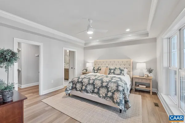 a bedroom with a bed and a potted plant