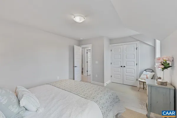 a spacious bedroom with a bed and a cabinets
