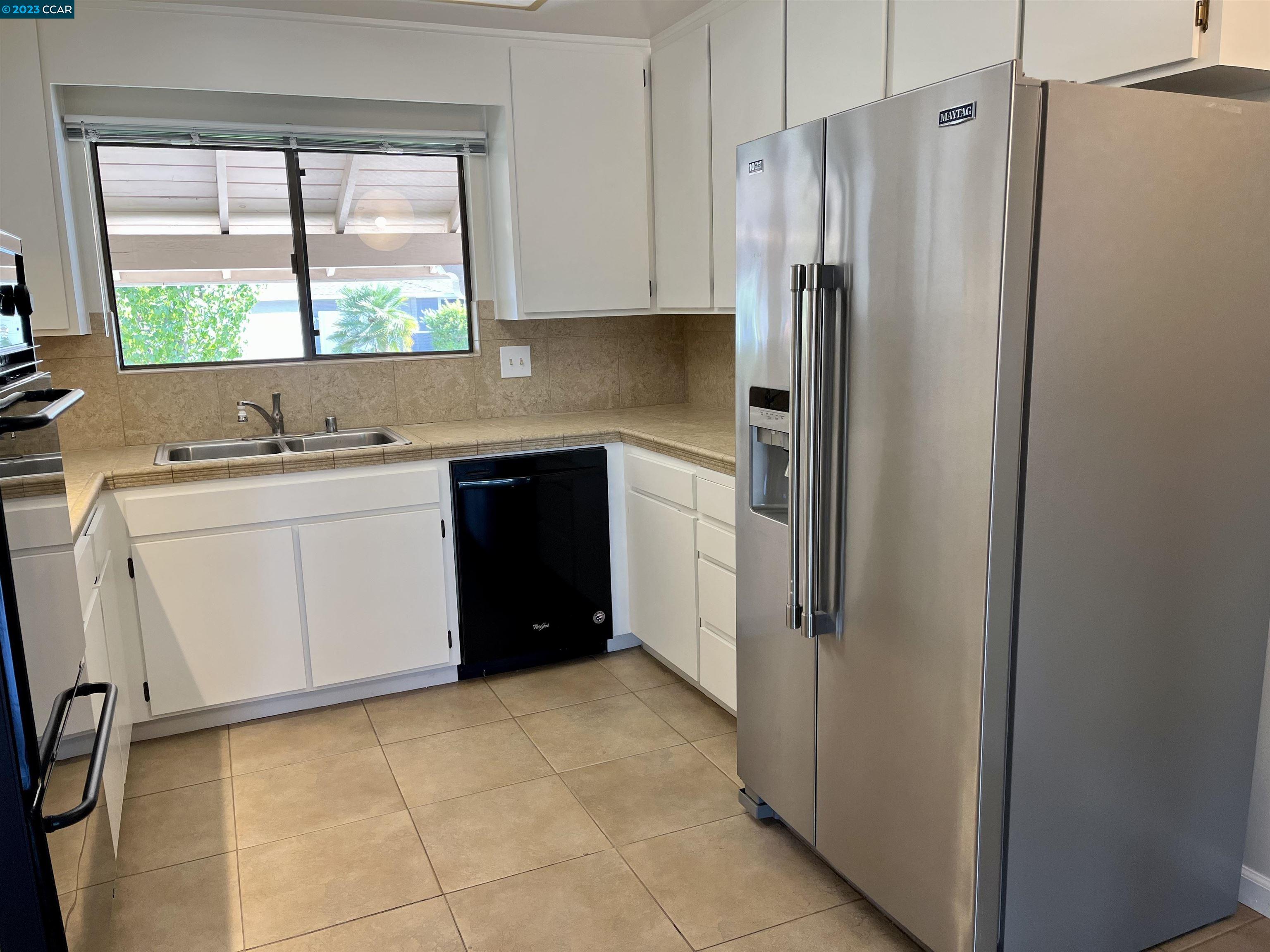 348 Barrett Circle Danville, CA 94526 - Photo 16 of 41 a kitchen with stainless steel appliances a refrigerator sink and window