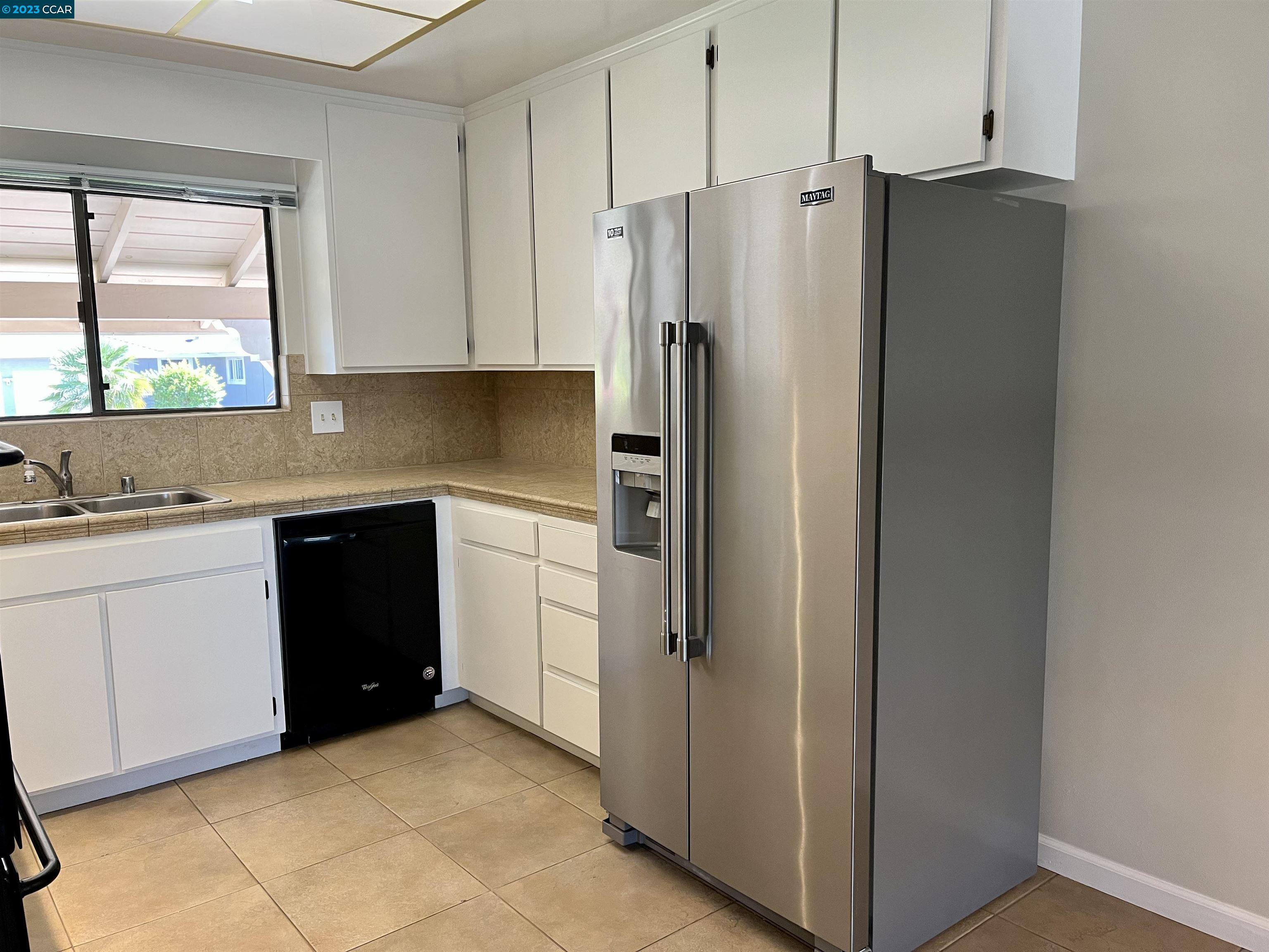 348 Barrett Circle Danville, CA 94526 - Photo 18 of 41 a kitchen with stainless steel appliances a refrigerator sink and cabinets